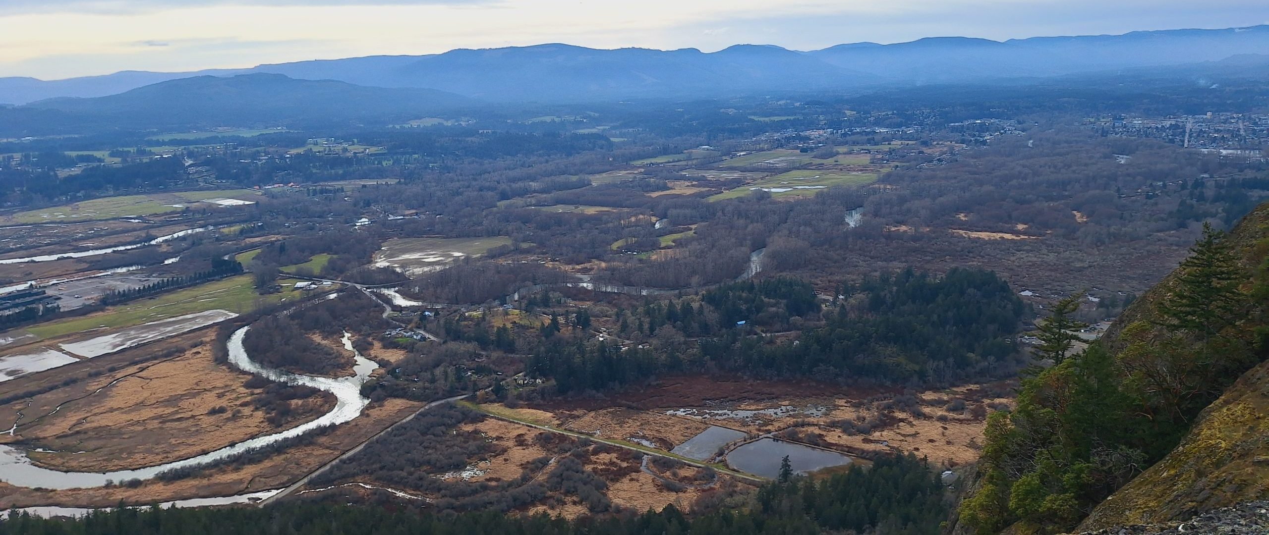 Panoramic view from Mt Tzouhalem trail overlooking Duncan and the Cowichan River estuary to Cowichan Bay and the Salish Sea